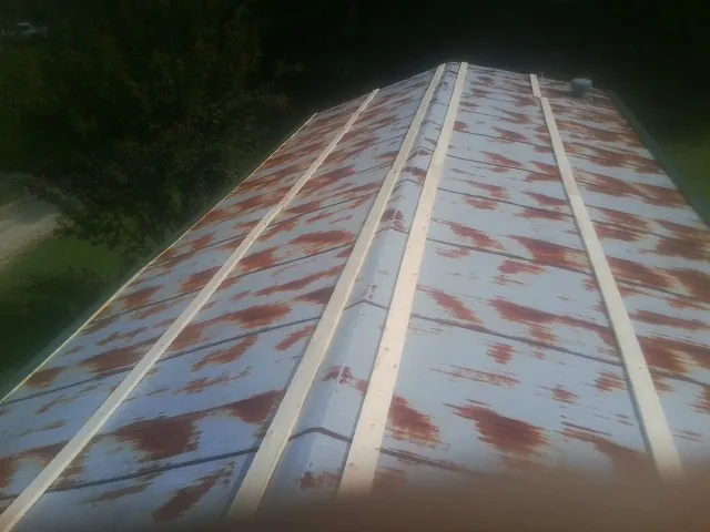 Rusted metal roof panels with new wood purlins before replacement — Storm Damage Roof Repair in Pink Hill by Roofing Brothers